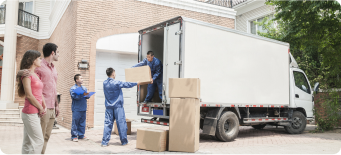 Movers unloading boxes from a truck while couple watches