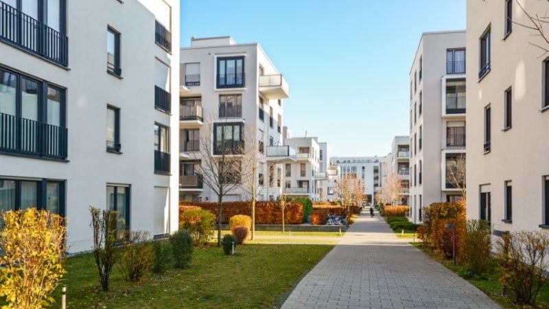 Condo complex with stone path and trees