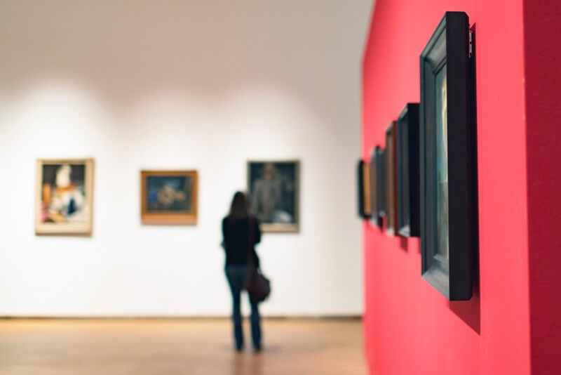 A person walking around viewing an art gallery