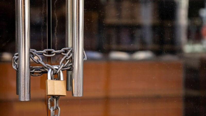 Doors with a lock and chain on a closed retail storefront