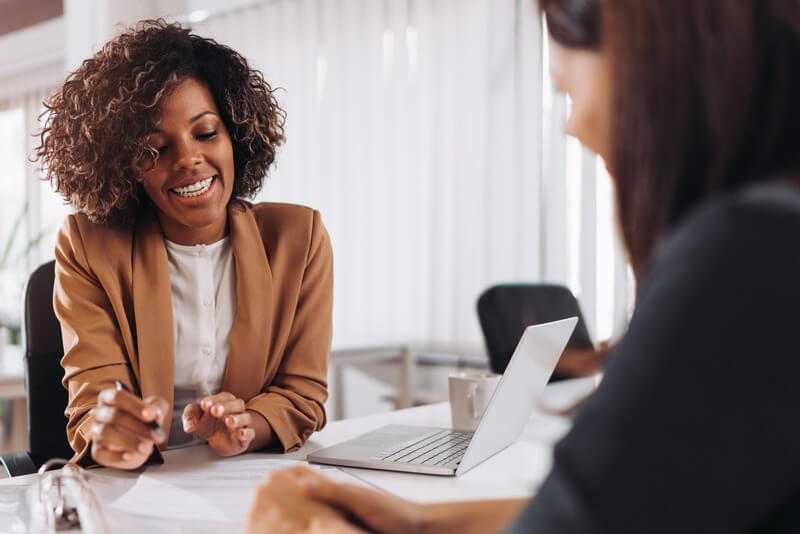 Finance professional reviewing paperwork with a client