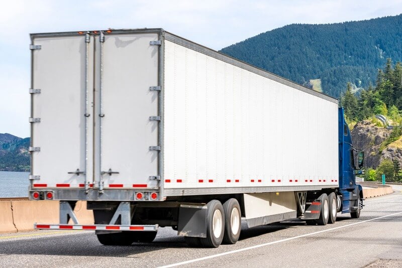 A semi-truck driving in the mountains
